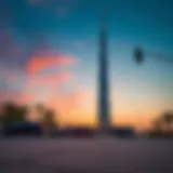 A stunning view of Al Kawsar Tower at sunset, showcasing its unique silhouette against the vibrant sky.
